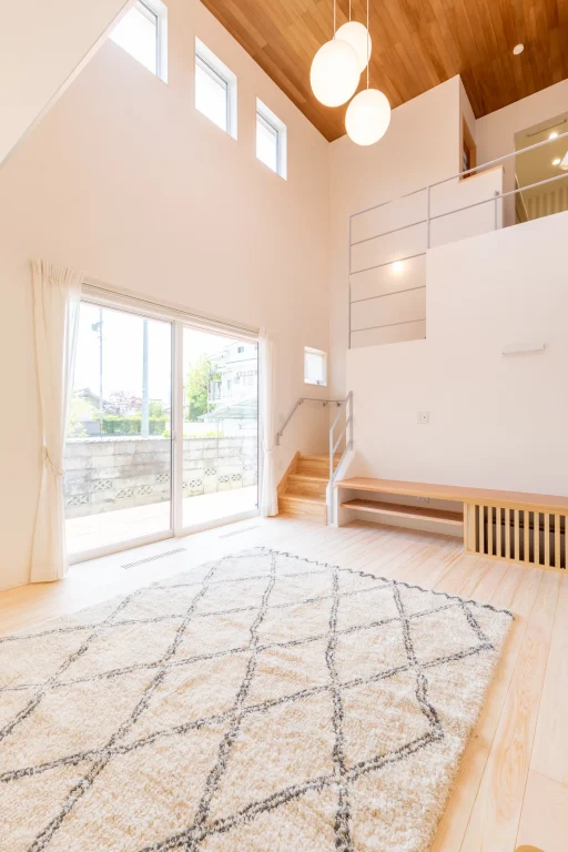 吹き抜けと木のぬくもりでつながる、明るい2階建ての住まい